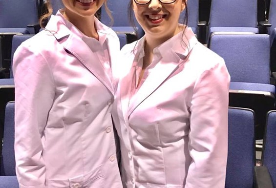 Image shows two female nursing students smiling and posing for a picture just after their graduation from Mineral Area College's Nursing Program