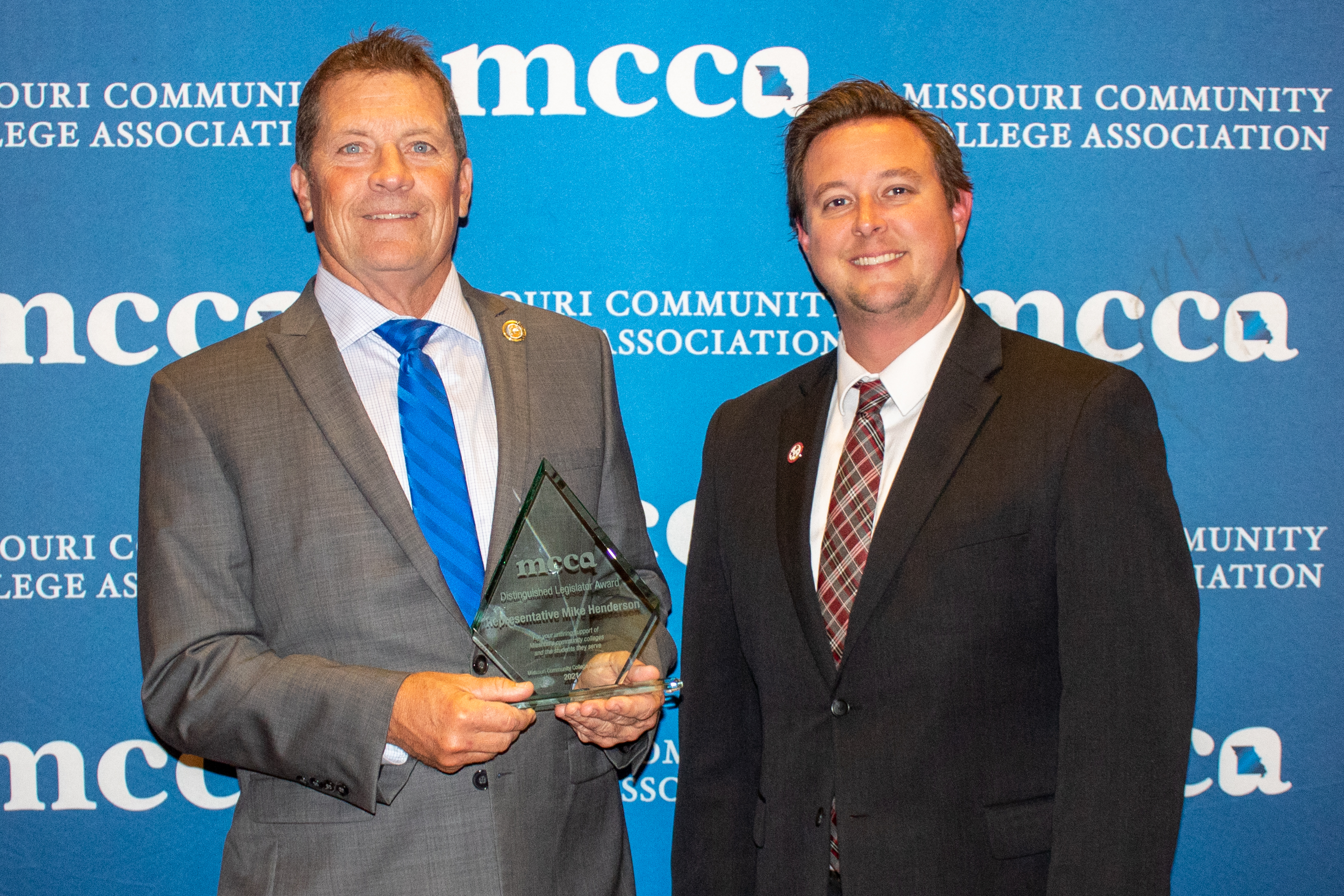 Image of Dr. Gilgour with Mr. Henderson accepting an award.