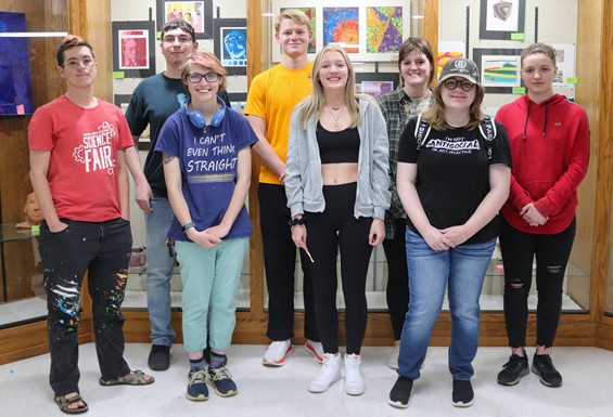 Image of students in front of an art exhibit. 